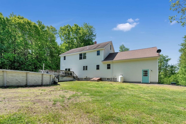 1505 Foxes Ridge Rd, Acton, ME 04001 - back of property with a lawn, a deck, and a chimney