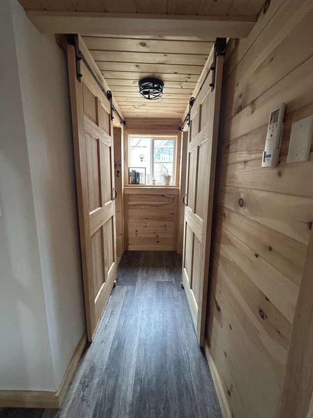 108 30th St, Shapleigh, ME 04076 - corridor with a barn door, wood walls, dark wood-style floors, wood ceiling, and baseboards