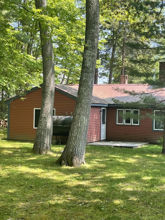 386 Lower Flying Point Rd, Freeport, ME 04032 - view of front of property with a chimney, a front lawn, and a metal roof