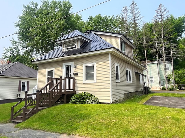 3 Baker St, Winslow, ME 04901 - view of front of property with metal roof, a front yard, and asphalt driveway