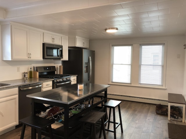 3 Baker St, Winslow, ME 04901 - kitchen featuring stainless steel appliances, a baseboard radiator, white cabinetry, and dark wood-style flooring