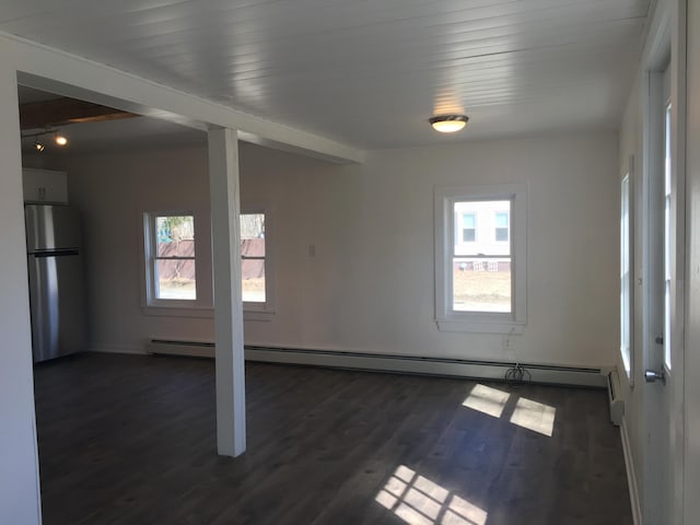 3 Baker St, Winslow, ME 04901 - empty room with healthy amount of natural light, a baseboard radiator, dark wood-style floors, and baseboards
