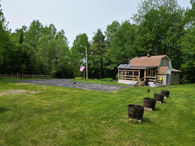 140 Station Rd, Lincoln, ME 04457 - view of green lawn with a sunroom and a wooden deck