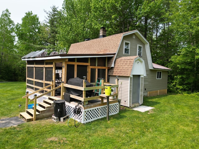 140 Station Rd, Lincoln, ME 04457 - rear view of property with roof with shingles, a gambrel roof, a lawn, a chimney, and view of scattered trees