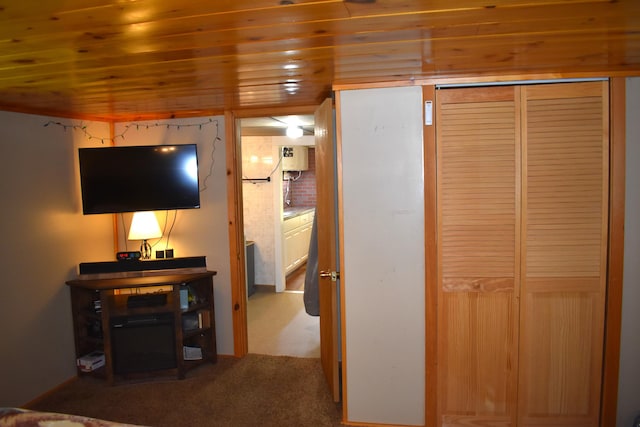 140 Station Rd, Lincoln, ME 04457 - carpeted bedroom featuring wood ceiling, a closet, and water heater
