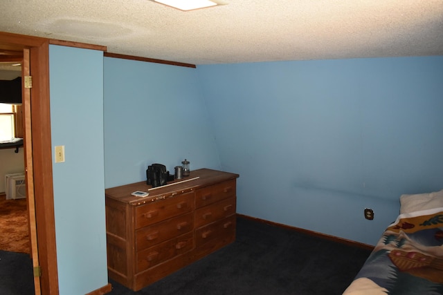 140 Station Rd, Lincoln, ME 04457 - bedroom featuring dark carpet and a textured ceiling