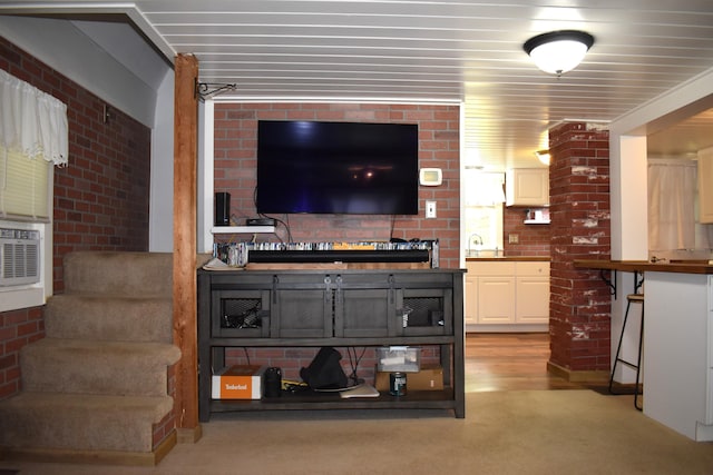 140 Station Rd, Lincoln, ME 04457 - living room with light colored carpet and brick wall