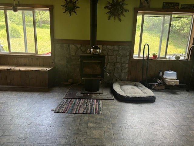 20 Coldbrook Rd, Hampden, ME 04444 - living area featuring a wood stove, wainscoting, and plenty of natural light