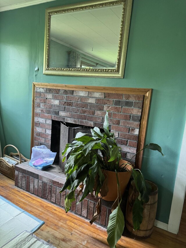 20 Coldbrook Rd, Hampden, ME 04444 - detailed view of wood finished floors, a fireplace, crown molding, and baseboards