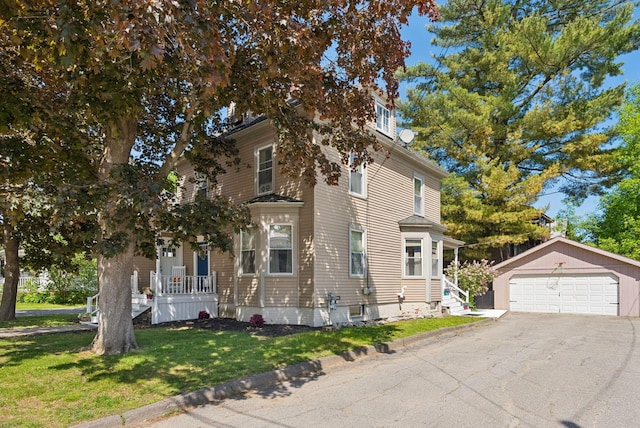 13 Bartlett St, Waterville, ME 04901 - view of front of house featuring an outdoor structure, a detached garage, and a front yard