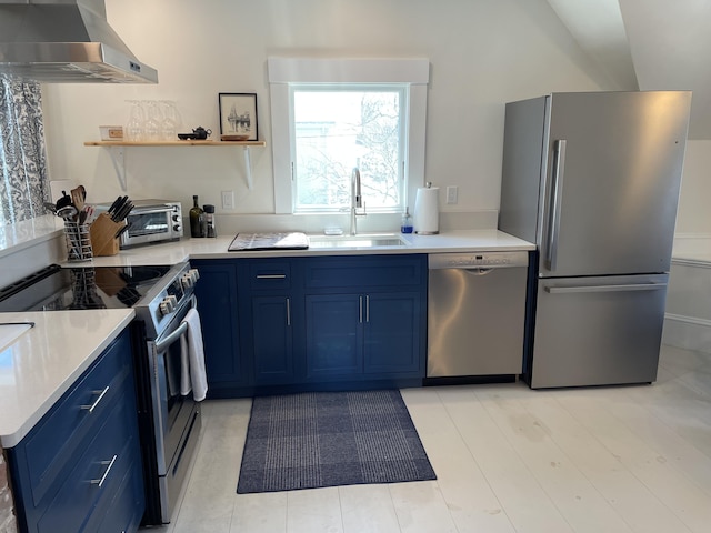138 Limerock St Unit A, Rockland, ME 04841 - kitchen with stainless steel appliances, wall chimney exhaust hood, blue cabinets, a sink, and light countertops