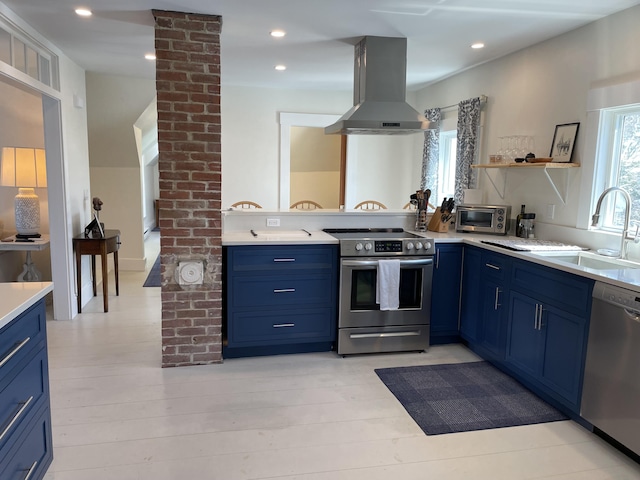 138 Limerock St Unit A, Rockland, ME 04841 - kitchen with stainless steel appliances, island range hood, blue cabinetry, a sink, and recessed lighting