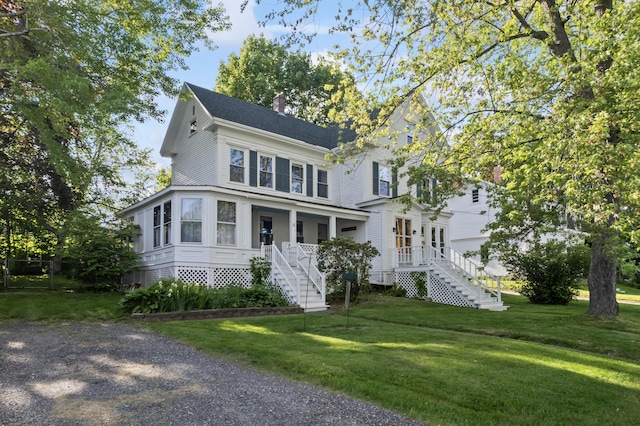 11 Center St, Richmond, ME 04357 - view of front of house with stairway, a chimney, covered porch, and a front lawn