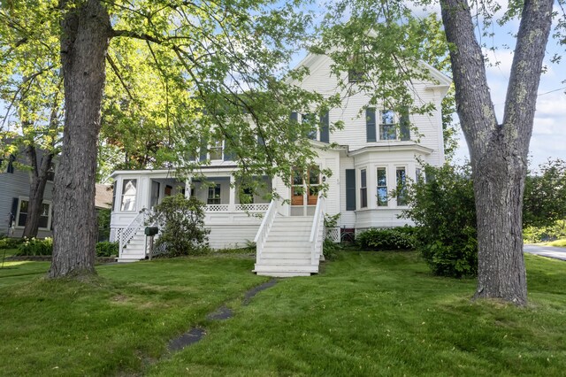 11 Center St, Richmond, ME 04357 - view of front facade featuring stairway and a front yard