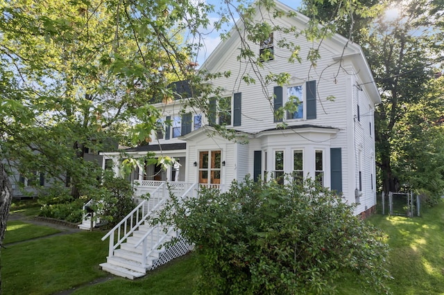 11 Center St, Richmond, ME 04357 - view of front facade featuring a front yard, a gate, stairs, and covered porch