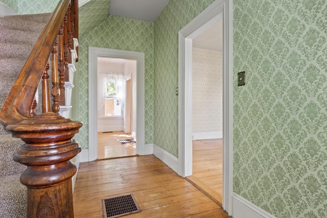 11 Center St, Richmond, ME 04357 - hallway featuring wood-type flooring, wallpapered walls, and baseboards
