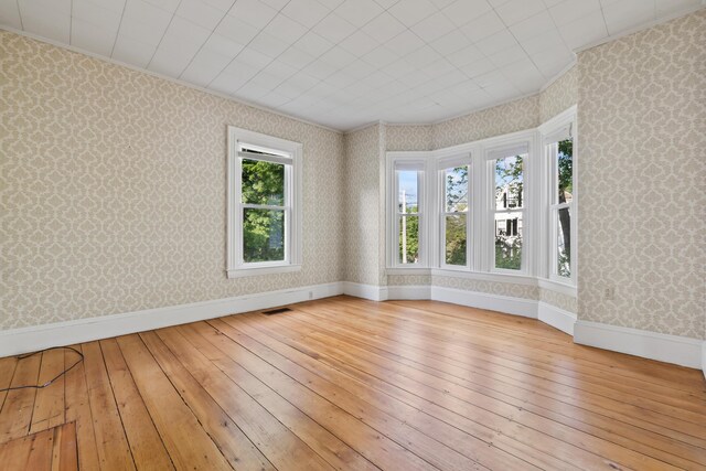 11 Center St, Richmond, ME 04357 - spare room with wallpapered walls, hardwood / wood-style floors, baseboards, and ornamental molding
