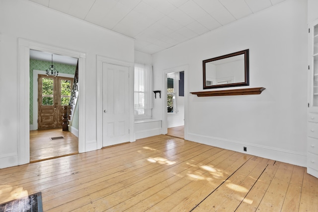 11 Center St, Richmond, ME 04357 - entryway featuring wood-type flooring, baseboards, and a chandelier