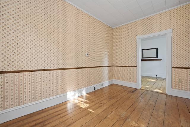 11 Center St, Richmond, ME 04357 - empty room with ornamental molding, wallpapered walls, hardwood / wood-style flooring, and baseboards