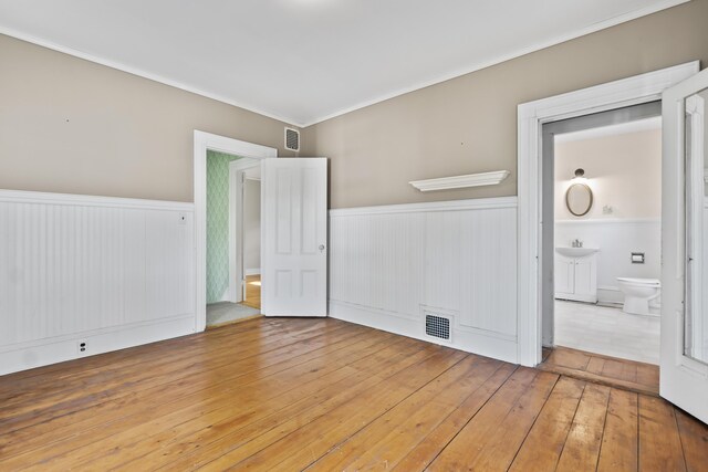 11 Center St, Richmond, ME 04357 - spare room featuring a wainscoted wall, hardwood / wood-style flooring, and ornamental molding