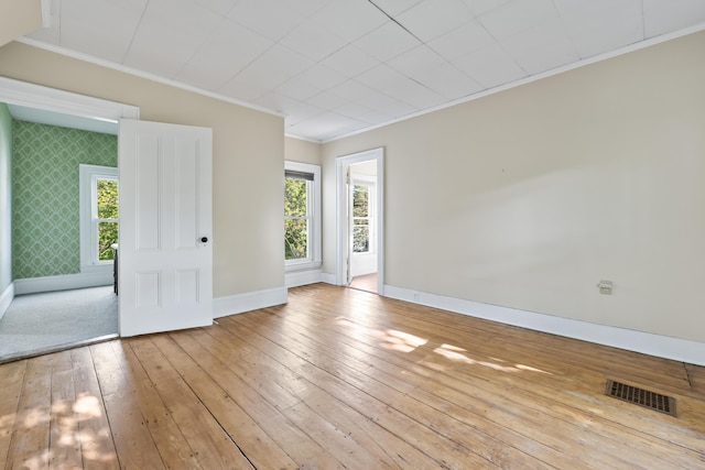 11 Center St, Richmond, ME 04357 - unfurnished room featuring crown molding, baseboards, wood-type flooring, plenty of natural light, and wallpapered walls