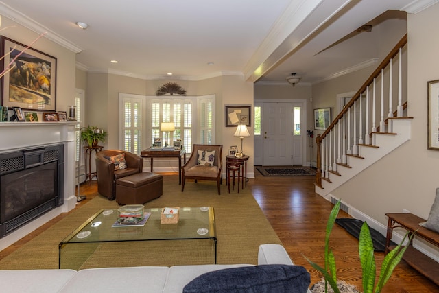10 Clam Cove Dr, Rockport, ME 04856 - living room featuring wood finished floors, a glass covered fireplace, baseboards, stairway, and crown molding