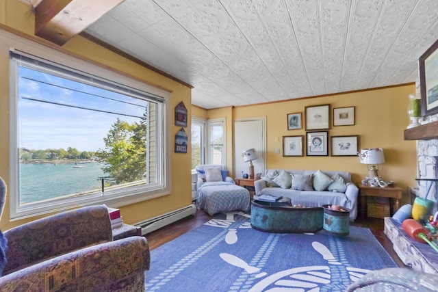 23 Western Ave, Boothbay Harbor, ME 04538 - living area featuring baseboard heating, wood finished floors, crown molding, and a water view