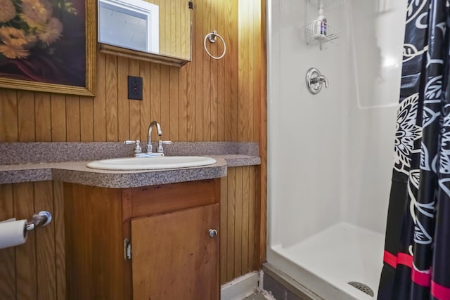 23 Western Ave, Boothbay Harbor, ME 04538 - full bathroom with a shower stall, vanity, and wooden walls