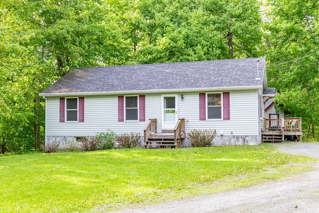 14 Carter Ln, Brewer, ME 04412 - view of front of house featuring a deck, a front lawn, and roof with shingles