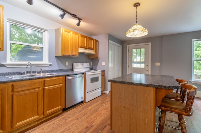 14 Carter Ln, Brewer, ME 04412 - kitchen with under cabinet range hood, white electric stove, dishwasher, a sink, and light wood finished floors