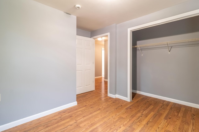 14 Carter Ln, Brewer, ME 04412 - unfurnished bedroom with baseboards, light wood-style flooring, and a closet