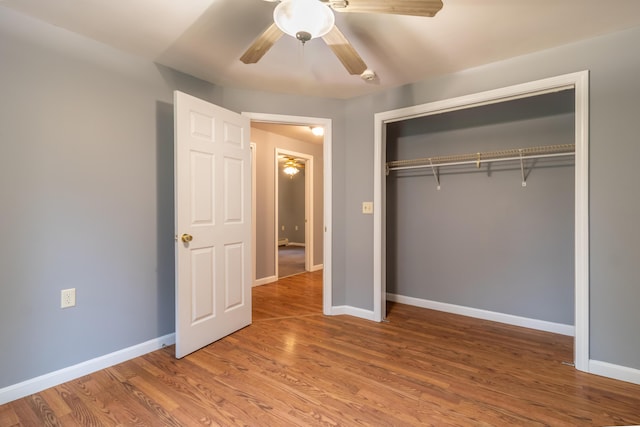 14 Carter Ln, Brewer, ME 04412 - unfurnished bedroom featuring baseboards, a closet, wood finished floors, and a ceiling fan