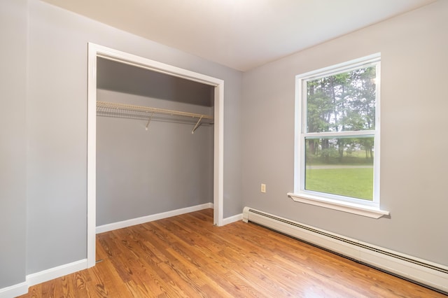 14 Carter Ln, Brewer, ME 04412 - unfurnished bedroom featuring baseboard heating, light wood-style flooring, a closet, and baseboards