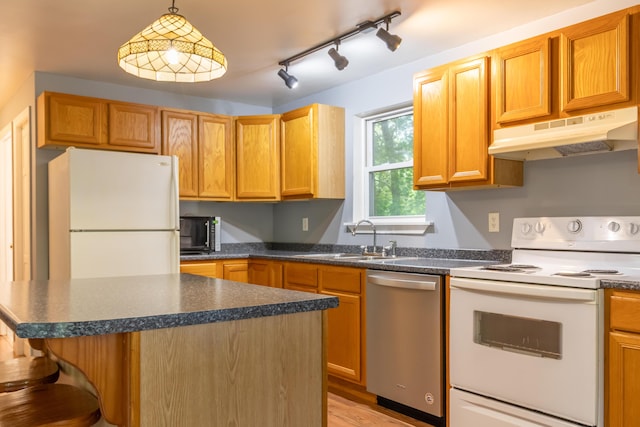 14 Carter Ln, Brewer, ME 04412 - kitchen with white appliances, under cabinet range hood, a sink, and dark countertops