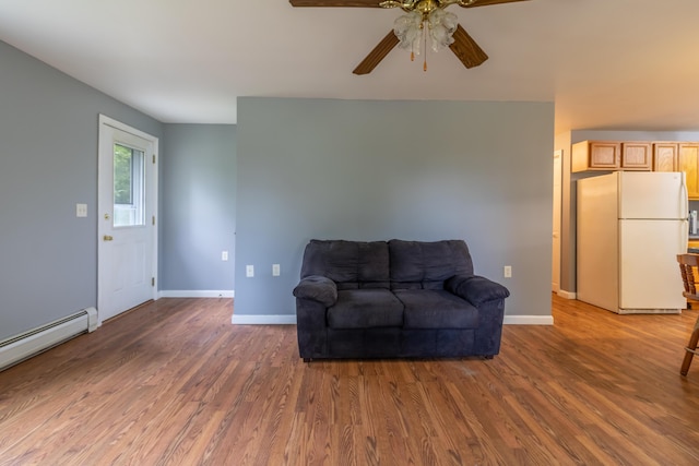 14 Carter Ln, Brewer, ME 04412 - sitting room with ceiling fan, a baseboard radiator, wood finished floors, and baseboards