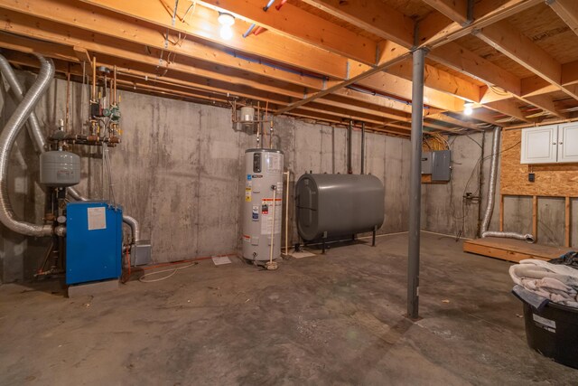 14 Carter Ln, Brewer, ME 04412 - unfinished basement featuring oil tank, water heater, electric panel, and a heating unit