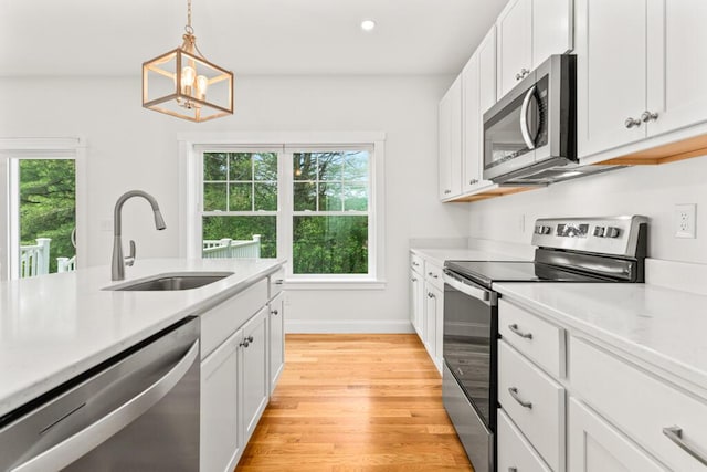 21 Arnies Alley -, Westbrook, ME 04092 - kitchen featuring appliances with stainless steel finishes, a sink, light countertops, light wood finished floors, and recessed lighting