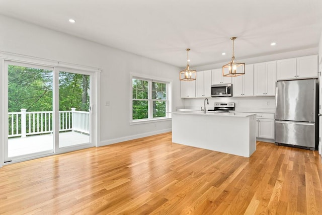 21 Arnies Alley -, Westbrook, ME 04092 - kitchen featuring appliances with stainless steel finishes, a sink, baseboards, light countertops, and light wood-style floors
