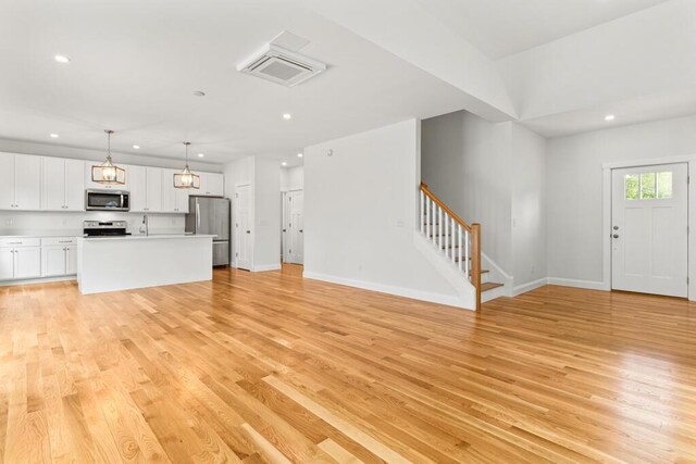 21 Arnies Alley -, Westbrook, ME 04092 - unfurnished living room with stairway, recessed lighting, light wood-style floors, and baseboards