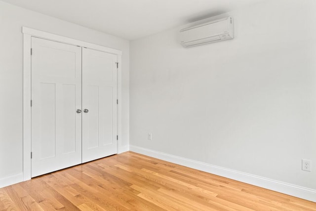 21 Arnies Alley -, Westbrook, ME 04092 - unfurnished bedroom with a wall mounted air conditioner, light wood-type flooring, baseboards, and a closet