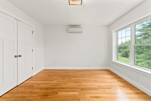 21 Arnies Alley -, Westbrook, ME 04092 - unfurnished bedroom with multiple windows, a wall mounted AC, and light wood finished floors