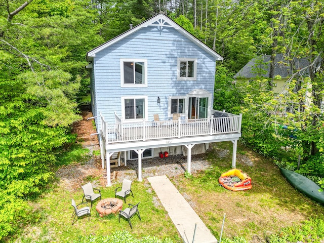 33-34 Gerber Ln, Monmouth, ME 04259 - rear view of property featuring an outdoor fire pit and a deck
