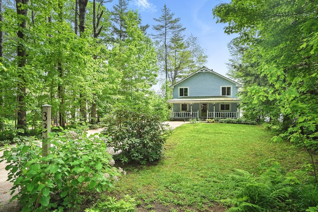 33-34 Gerber Ln, Monmouth, ME 04259 - back of house featuring covered porch and a lawn