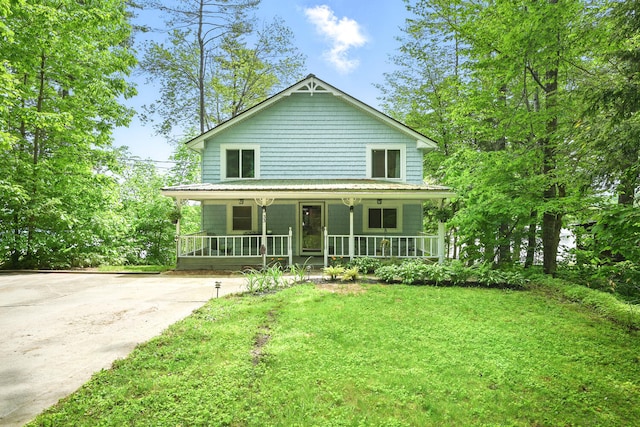 33-34 Gerber Ln, Monmouth, ME 04259 - view of front of property with covered porch and a front lawn