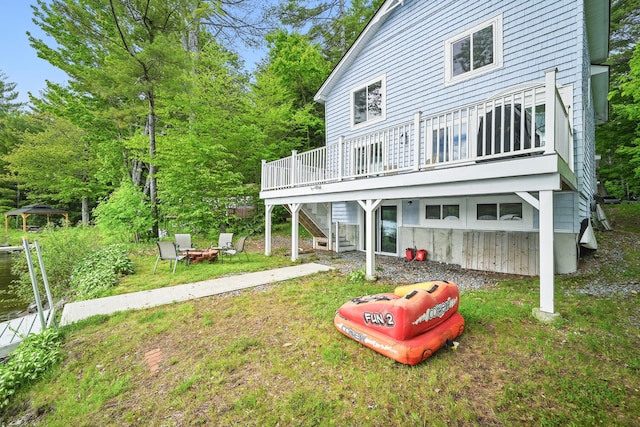 33-34 Gerber Ln, Monmouth, ME 04259 - back of house with an outdoor fire pit, stairway, a deck, and a yard