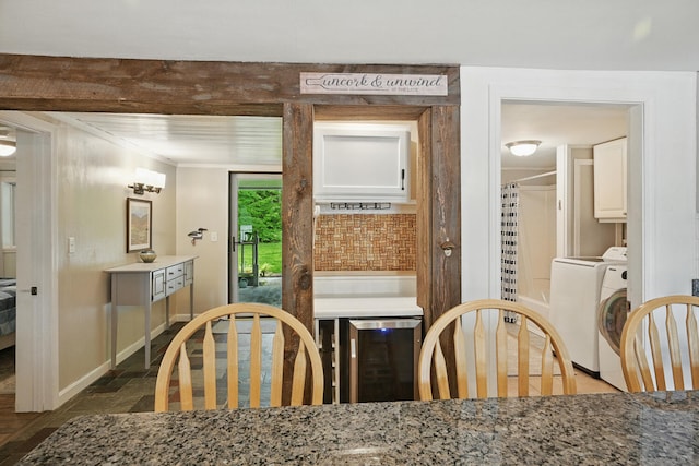 33-34 Gerber Ln, Monmouth, ME 04259 - dining room with beverage cooler, washer / clothes dryer, and dark stone finish floors
