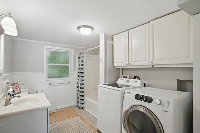 33-34 Gerber Ln, Monmouth, ME 04259 - laundry area with washer and clothes dryer, light tile patterned floors, a wainscoted wall, and crown molding