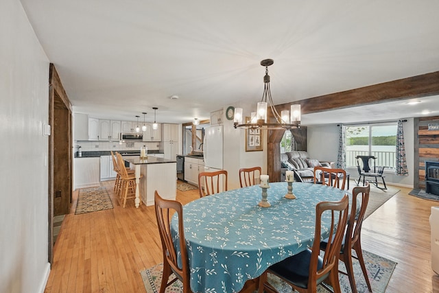 33-34 Gerber Ln, Monmouth, ME 04259 - dining room with a chandelier, light wood-type flooring, and beam ceiling