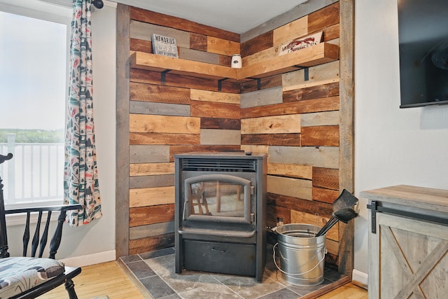 33-34 Gerber Ln, Monmouth, ME 04259 - detailed view of wood walls, a wood stove, and wood finished floors