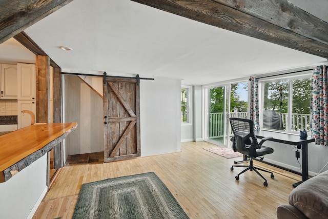 33-34 Gerber Ln, Monmouth, ME 04259 - home office with a barn door and light wood-type flooring